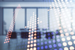 Upward arrows superimposed on a photo of an office