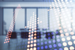 Upward arrows superimposed on a photo of an office