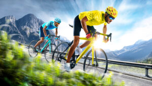 two sports people on bikes racing on a road, one is gaining an advantage