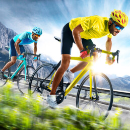 two sports people on bikes racing on a road, one is gaining an advantage